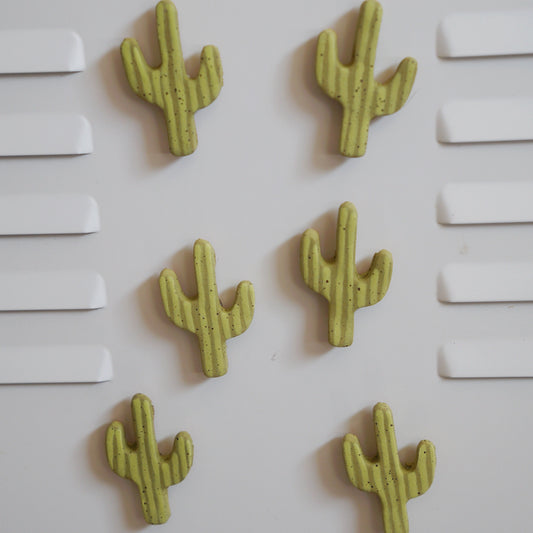 Five green cactus-shaped objects on a white background